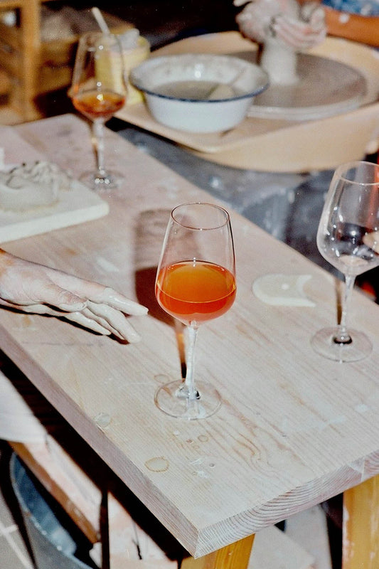 Wine glasses with orange liquid on a wooden table