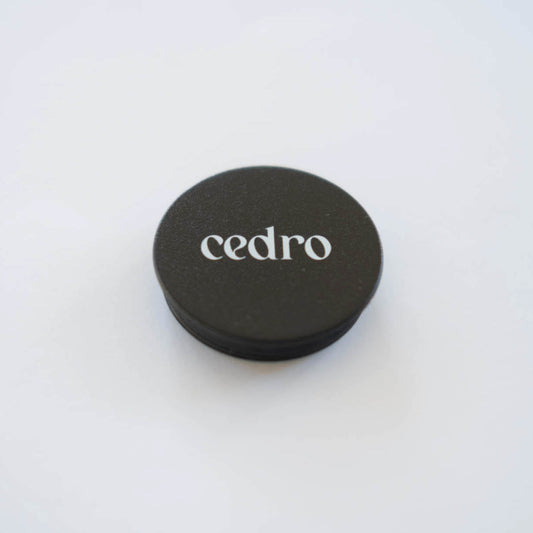 Black round pop socket with 'cedro' branding on a white background