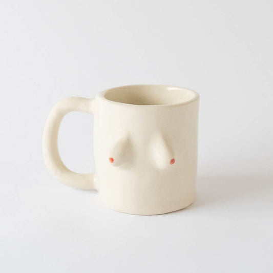 Beige breast mug shaped like a female torso with red dots that represent tits.