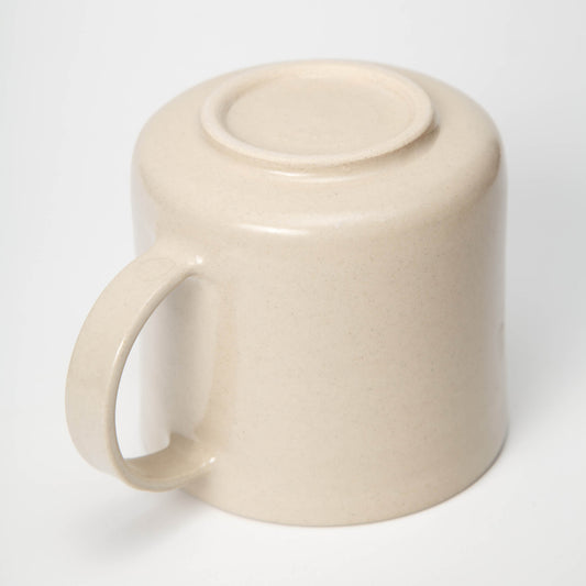 Beige ceramic mug with a lid on a white background