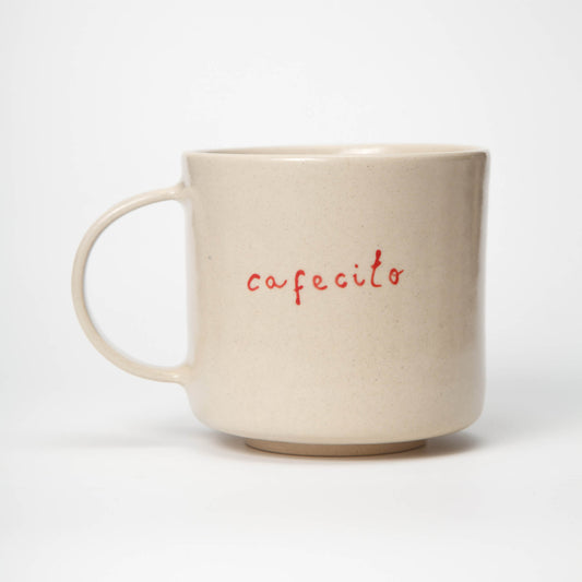 Beige mug with 'cafecito' text on a white background