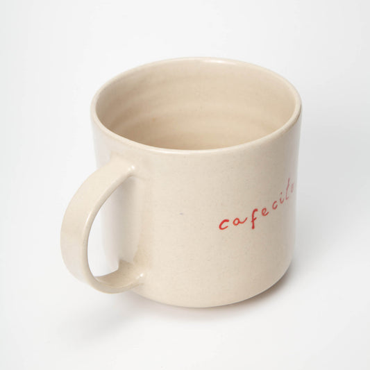 Beige mug with 'cafe' text on a white background
