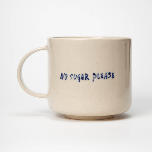 Beige mug with 'No Sugar Please' text on a white background