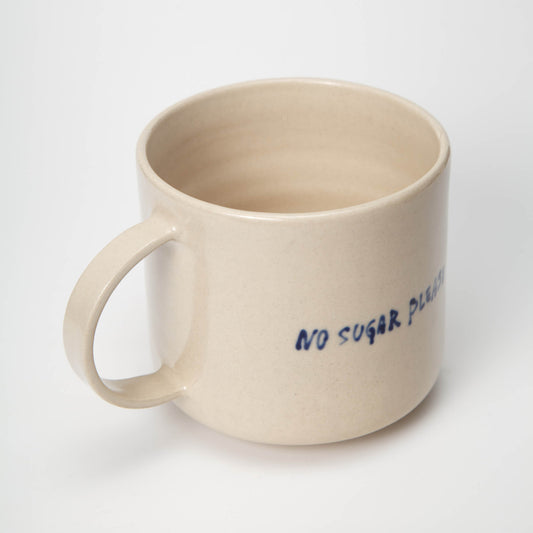 Beige mug with 'No Sugar Please' text on a white background
