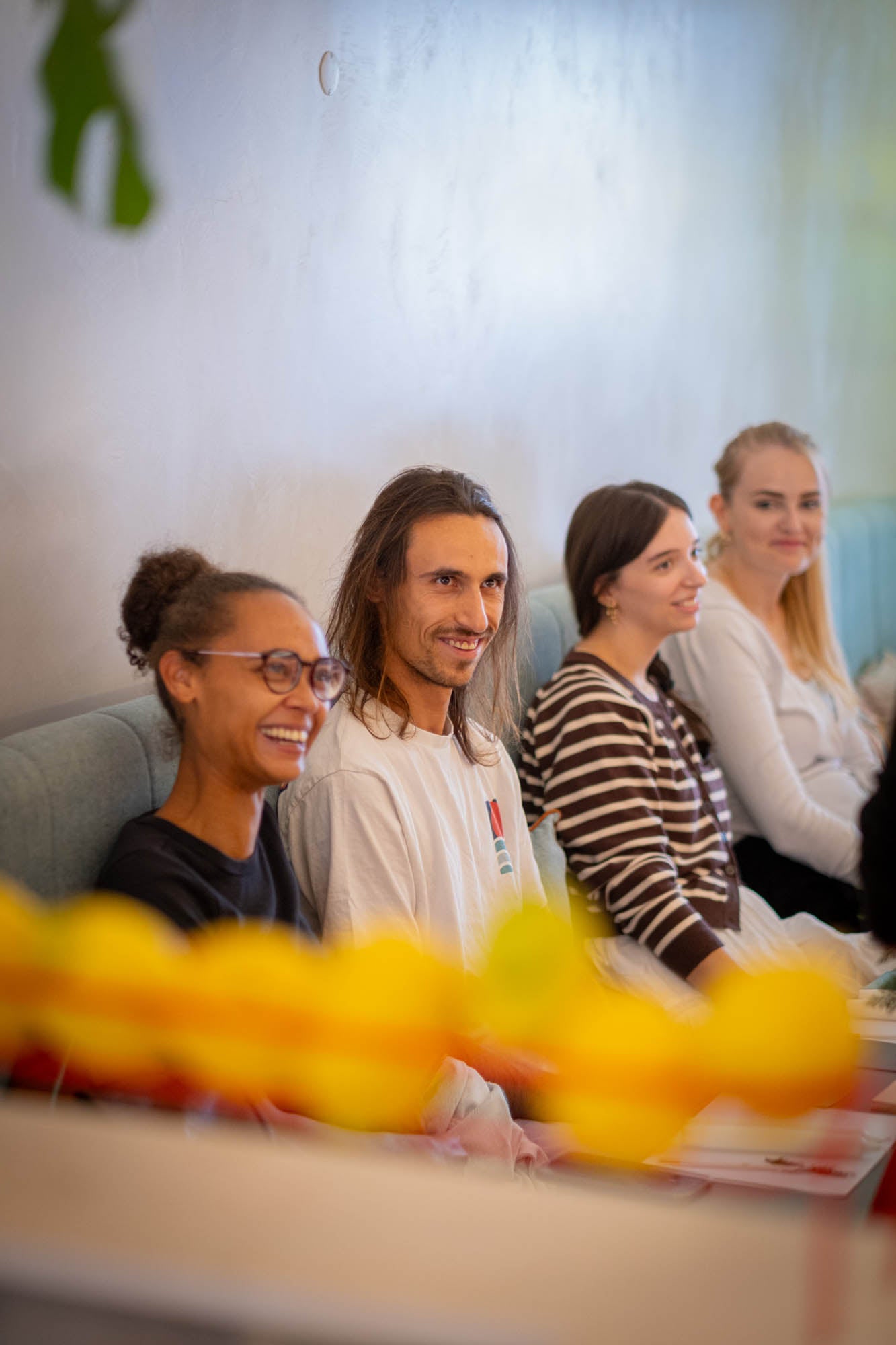 Group of people sitting together with a blurred foreground