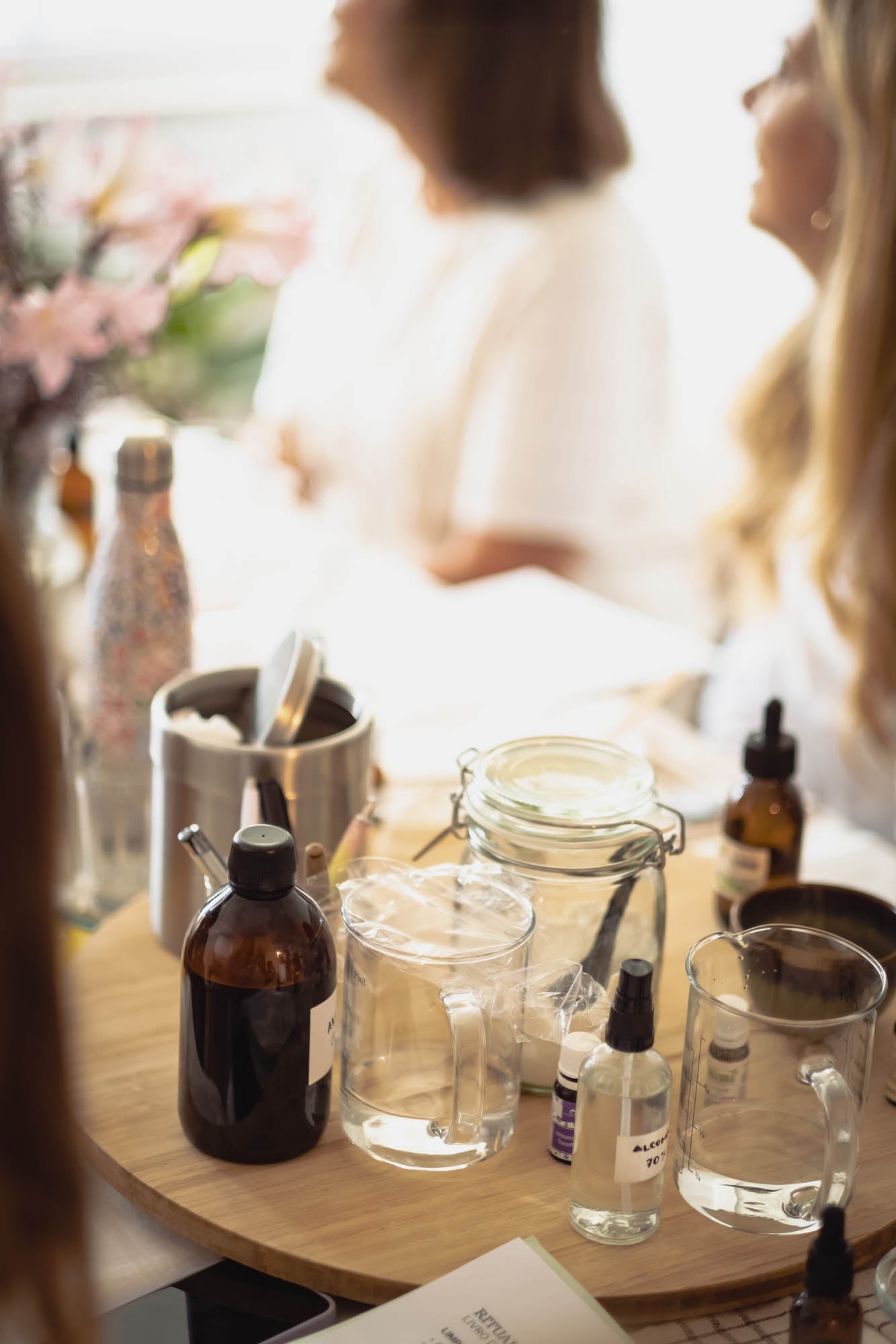 Table with skincare products and women in the background