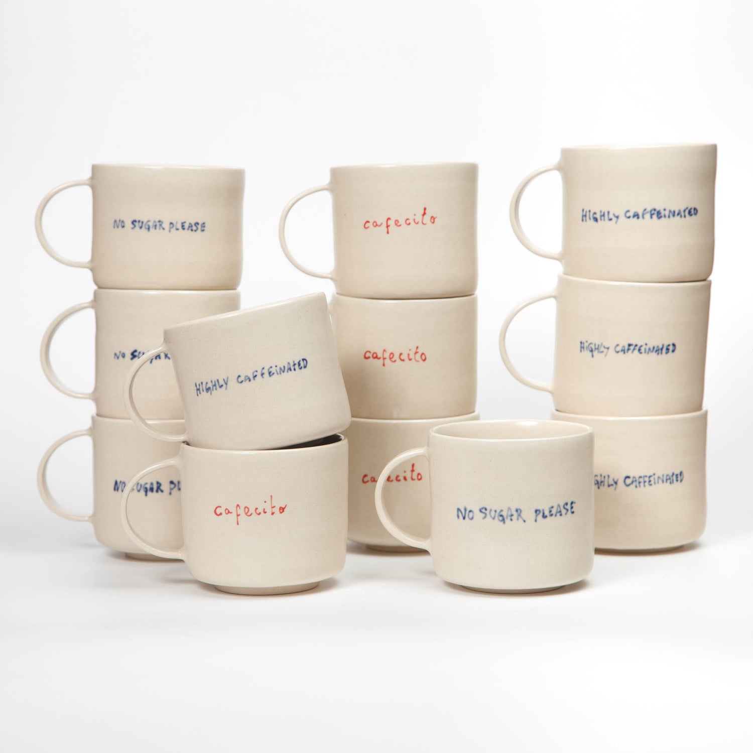 Set of ceramic mugs with text on a white background